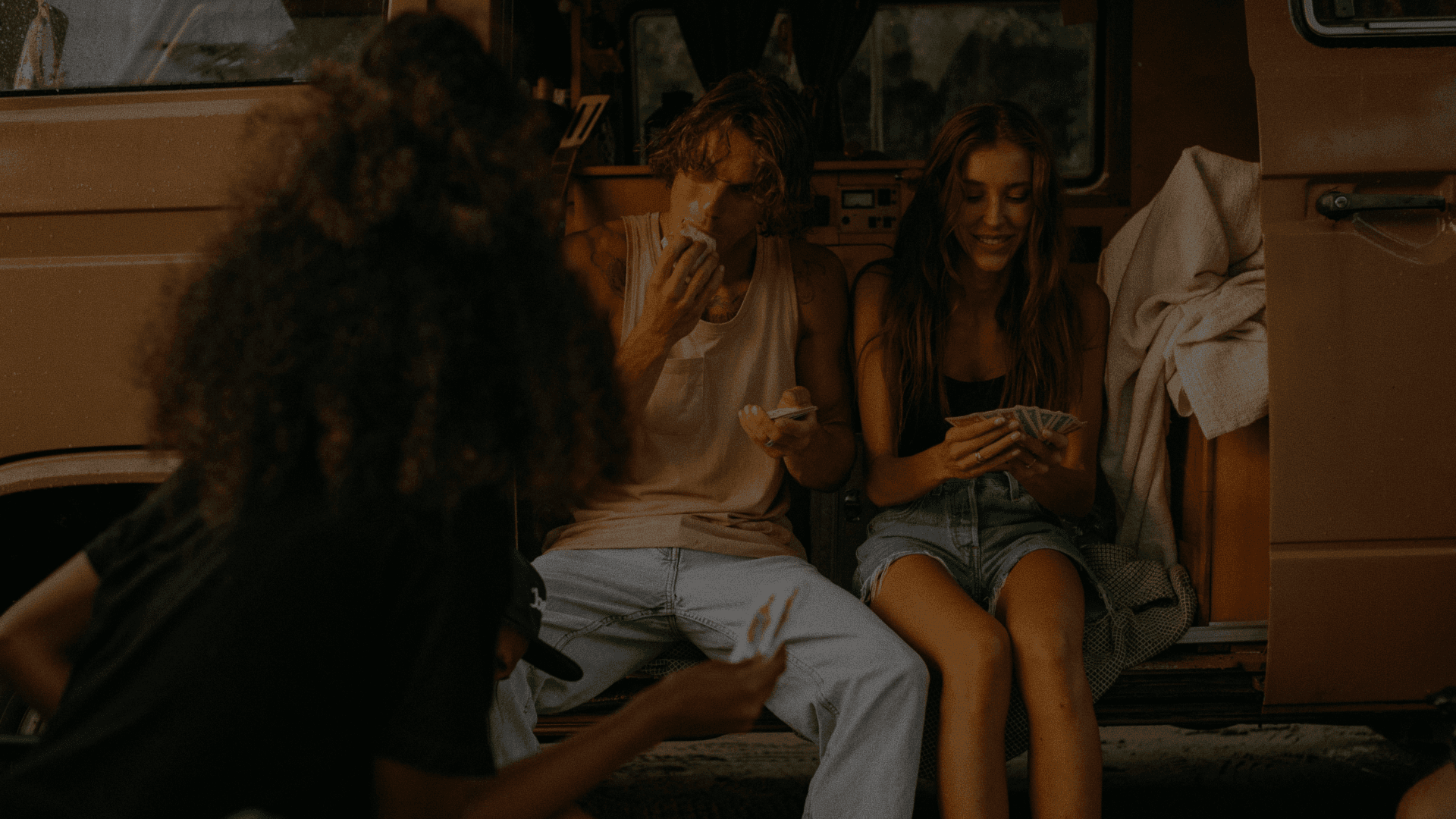 Friends enjoying time together outdoors by a van